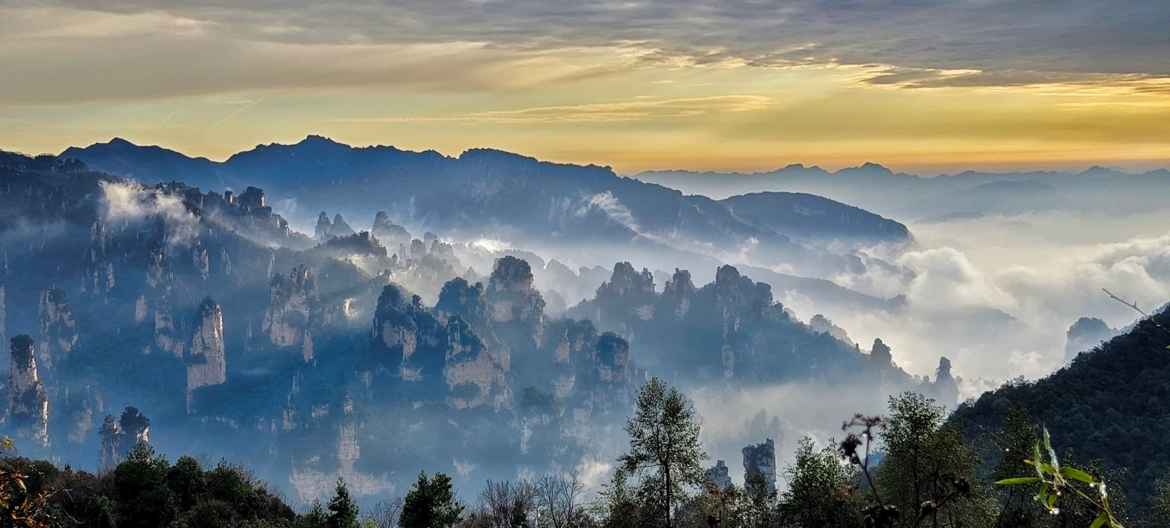 Layered sandstone peaks and low cloud at Tianzi Mountain